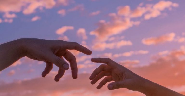 people reaching hands to each other