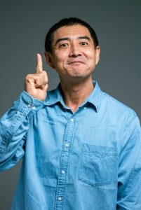 man in blue top finger pointing up
