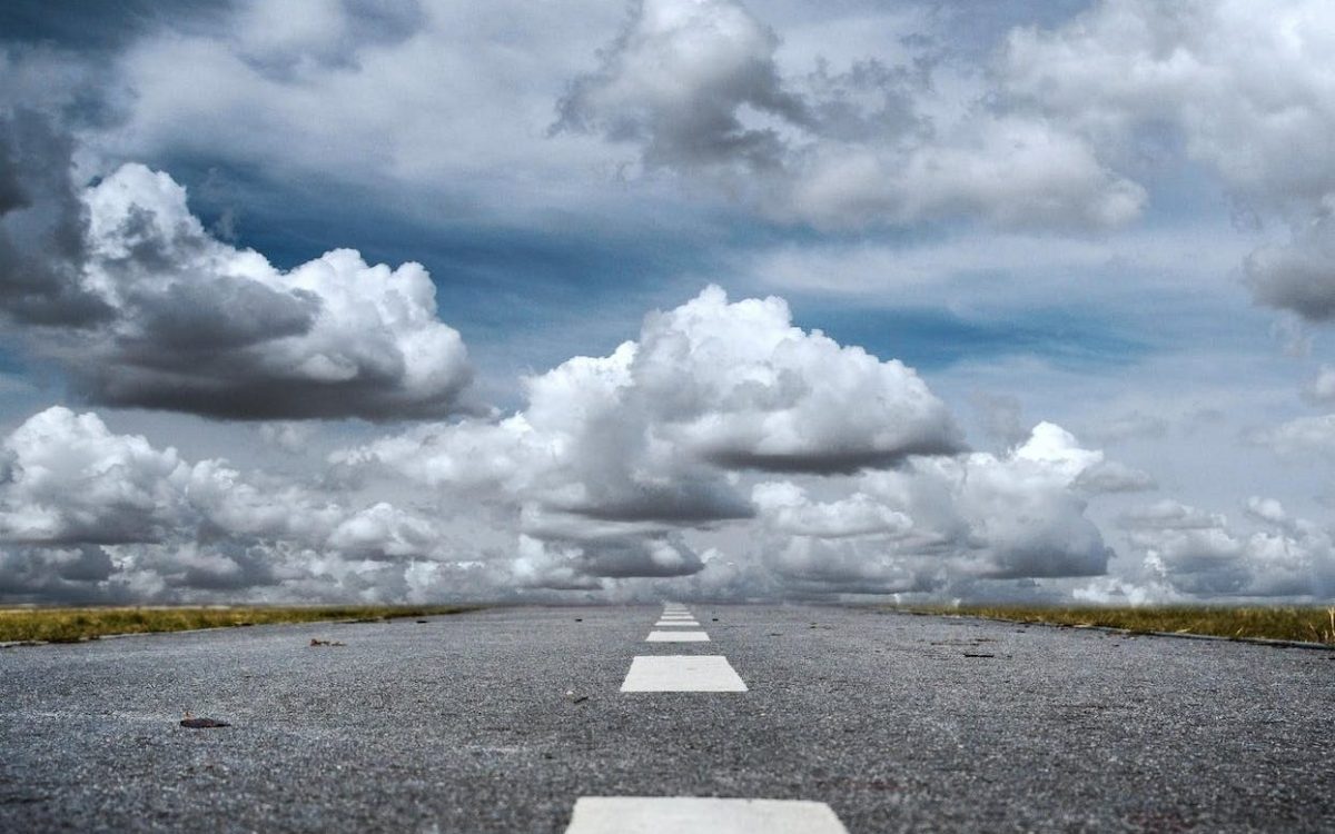 gray rolled asphalt road under cloudy sky