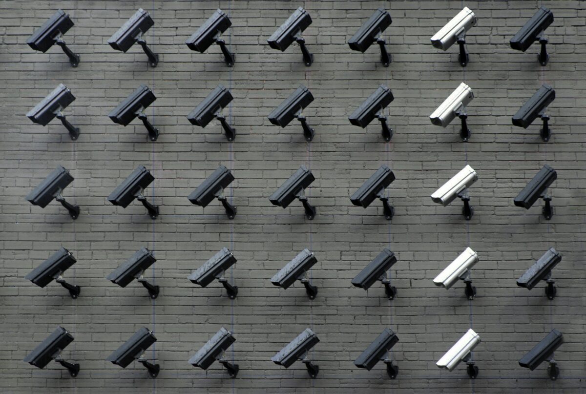 Many surveillance cameras on a wall